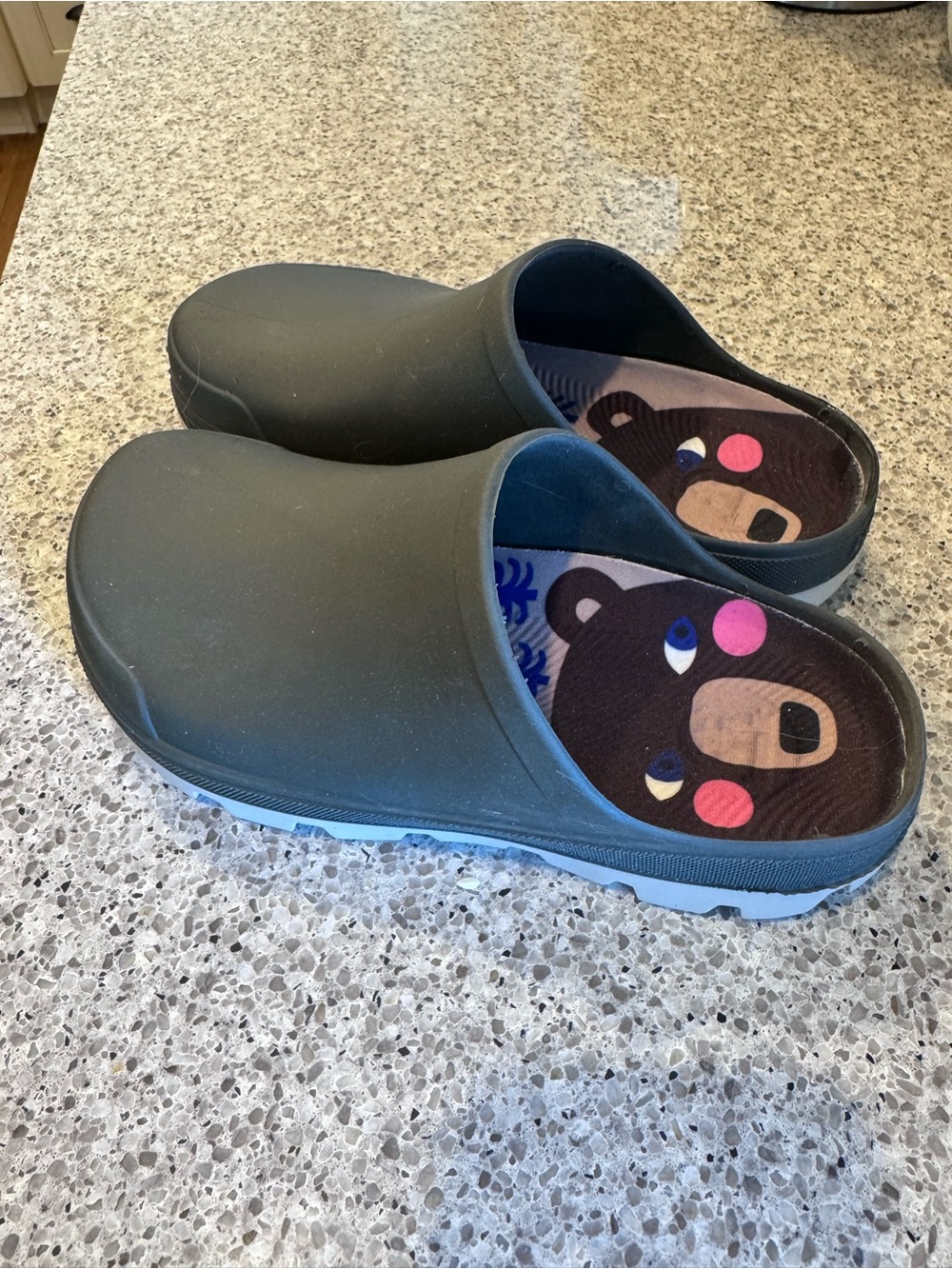 Kamik women's clogs in dark green with blue sole and playful bear insole